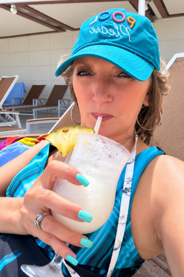 Teresa enjoying a frozen cocktail poolside on a Royal Caribbean cruise