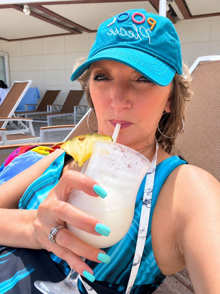 Teresa enjoying a frozen cocktail poolside on a Royal Caribbean cruise